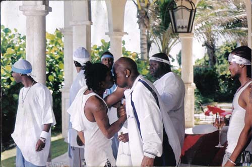 Hip Hop artist Lil Wayne greets his mentor, Bryant 'Baby' Williams with a kiss on the lips.
